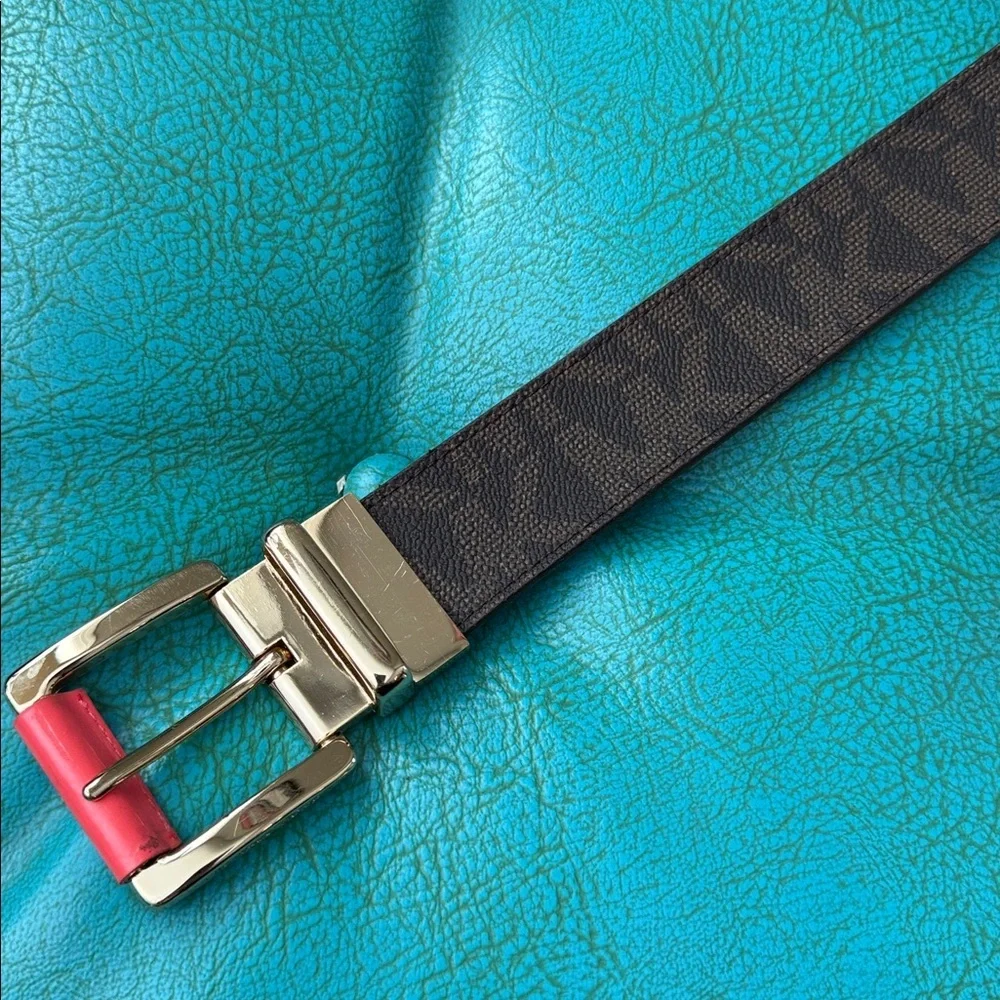 Reversible Michael Kors MK logo belt with bright shiny coral side - see flaw